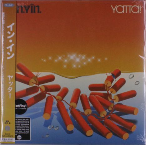 Text: "Yatta!", "イン・イン", "ヤッター!". Illustration: Rote dynamitartige Objekte im Wasser unter einem orange-gelben Himmel.