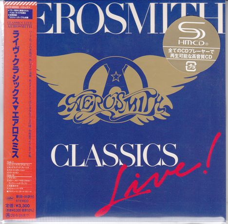 "CLASSICS Live!" in weiß und rot. Aerosmith-Logo mit Flügeln auf blauem Hintergrund. Japanische Schriftzeichen.