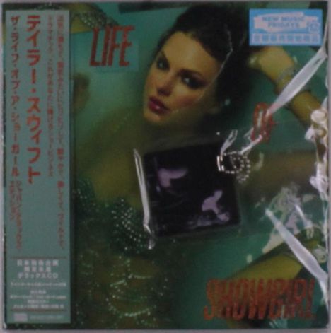 Text: "LIFE", "SHOWGIRL". Illustration einer Frau in glamouröser Pose mit Schmuck und grüner Bekleidung.