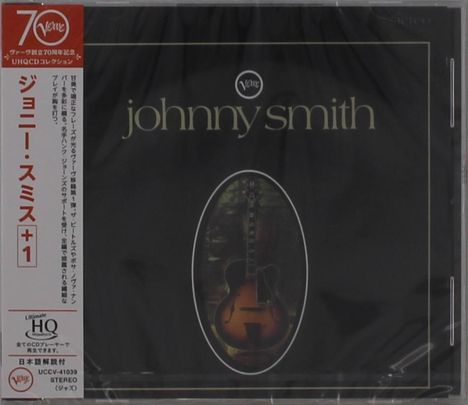 "Johnny Smith" steht in eleganter Schrift. Links ein japanischer Text. Mittig ein Bild einer Gitarre in einem Oval.