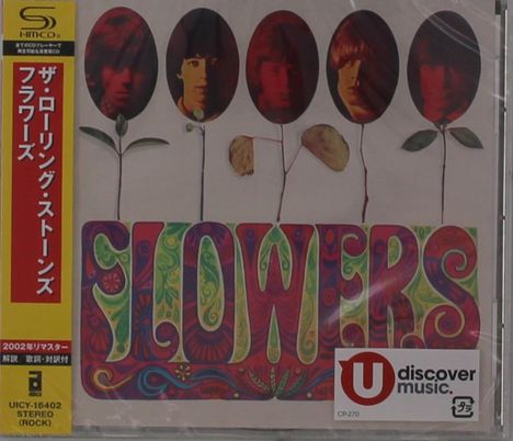 Text: "FLOWERS", daneben Gesichter auf Blütenstielen. Buntes, psychedelisches Design mit japanischem Text links.