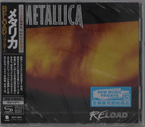 Metallische Schrift oben, "RELOAD" unten, vertikaler Text links. Hintergrund in warmen, flammenartigen Gelb-Orange-Tönen.