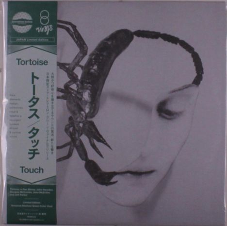 "Japan Limited Edition. Tortoise. Touch." Ein Gesicht überlagert von einem großen Skorpion.