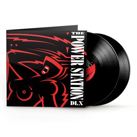 "THE POWER STATION DLX" steht auf einem Plattencover, das ein stilisiertes, rot akzentuiertes Gesicht zeigt. Im Hintergrund sind zwei schwarze Vinyl-Schallplatten sichtbar.
