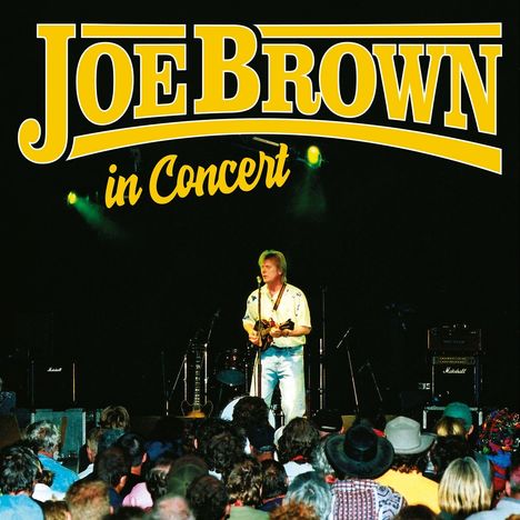 "Joe Brown in Concert" steht oben. Eine Person spielt Mandoline auf einer Bühne vor einem Publikum.