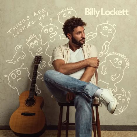 Text: "Things are looking up!" und "Billy Lockett". Mann sitzt auf Stuhl neben Gitarre, umgeben von lustigen Kritzeleien.