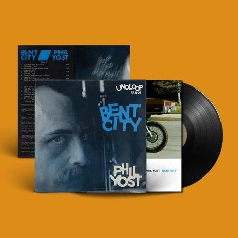 Aufschrift "BENT CITY PHIL YOST" im Vordergrund eines Vinyl-Albums, auf orangebraunem Hintergrund.