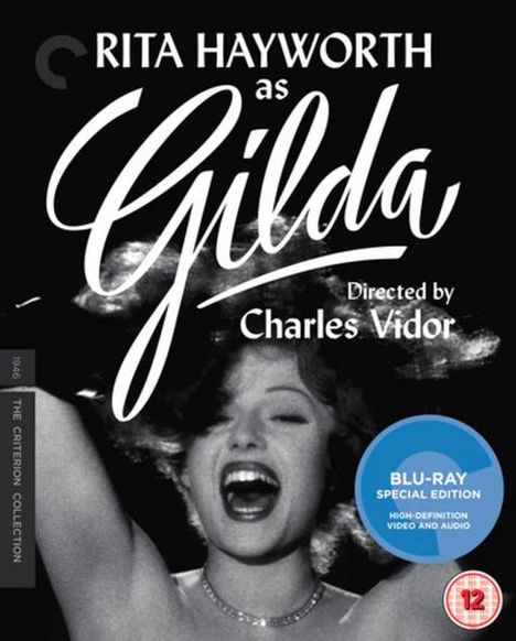 "RITA HAYWORTH as Gilda, Directed by Charles Vidor." Schwarz-Weiß-Foto einer Frau mit offenem Mund und erhobenem Arm.