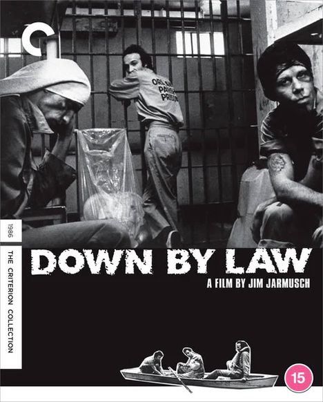 Text: DOWN BY LAW, A FILM BY JIM JARMUSCH. Drei Männer in einer Gefängniszelle, monochromes Bild, Boot-Symbol unten.