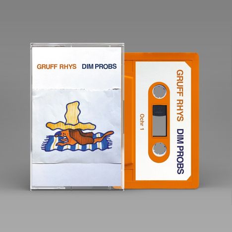 Texte: "GRUFF RHYS DIM PROBS". Orange Kassette. Illustration: Ein brauner Hund auf einem gestreiften Teppich.