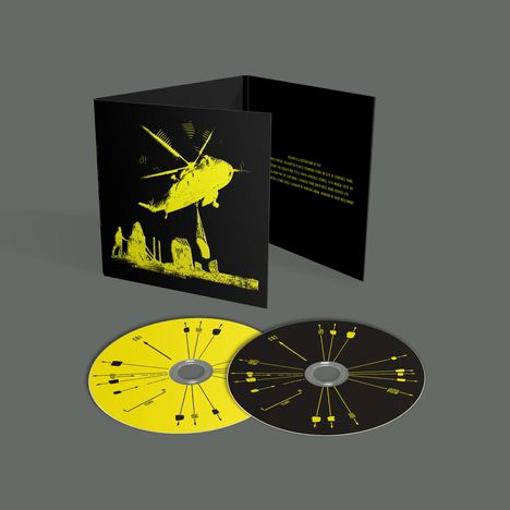 Das Bild zeigt zwei CDs und eine Hülle. Die Hülle hat gelben Text und eine Illustration eines Helikopters.
