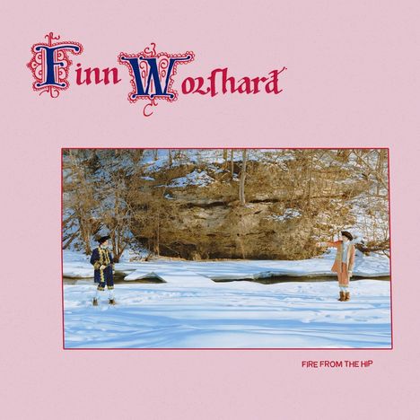 "Finn Wolfhard" in kunstvoller Schrift, darunter "FIRE FROM THE HIP". Zwei kostümierte Personen im Schnee mit Felsen.
