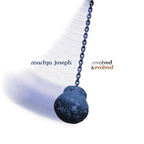 Text: "martyn joseph revolved & evolved." Eine schwarze Kette hängt mit einer großen, dunklen Kugel daran.