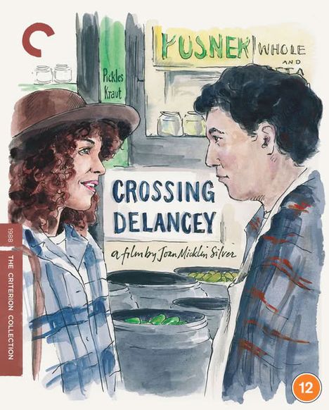 „CROSSING DELANCEY, a film by Joan Micklin Silver.“ Zwei Personen unterhalten sich vor einem Marktstand.