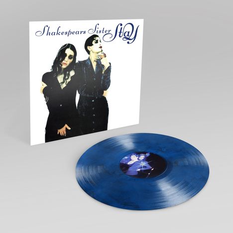 "Shakespears Sister" und "Stay" in blauer Schrift stehen auf einem Albumcover. Darunter zwei Frauen in dunkler Kleidung; eine blaue Vinylplatte.