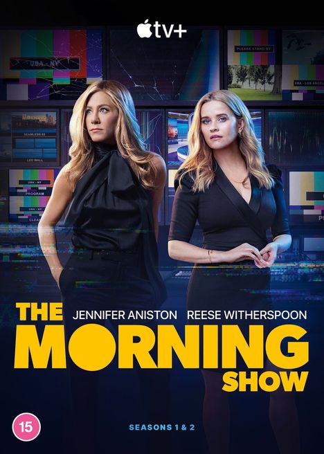 "The Morning Show", Apple TV+, Jennifer Aniston und Reese Witherspoon stehend. Bunte Fernsehwände im Hintergrund.