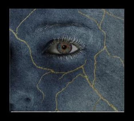 Ein Auge in einem blaugrauen Gesicht mit goldenen Rissen, erinnert an eine Steinstruktur.