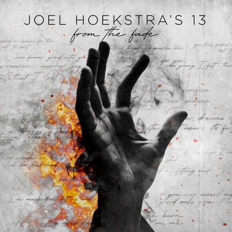 "JOEL HOEKSTRA'S 13, from the fade." Eine dramatische Hand ragt aus Flammen und Rauch hervor.