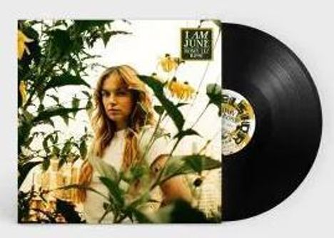 Text: "I AM JUNE." Frau mit langen Haaren in einem Garten, Schallplatte im Hintergrund.