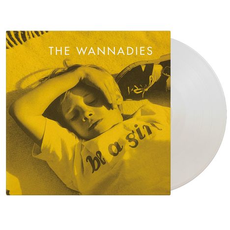 Text: "THE WANNADIES" und "be a girl". Gelbes Bild eines entspannten Kindes mit hochgelegtem Arm. Vinyl-Schallplatte sichtbar.