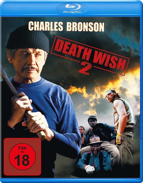 Texts: Charles Bronson, Death Wish 2, FSK ab 18. Illustration: Ein Mann in dunkler Kleidung, Flammen im Hintergrund.