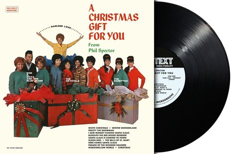 "A Christmas Gift for You From Phil Spector." Bunte Gruppe mit Geschenken, fröhlicher Ausdruck, Vinyl-Schallplatte.