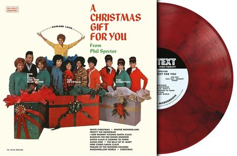 Auf dem Cover in roten Buchstaben "A Christmas Gift For You From Phil Spector". Gruppen posieren hinter Geschenken.