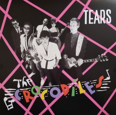"TEARS" und "THE CROCODILES" in bunten Buchstaben. Eine Gruppe von sieben Personen mit Instrumenten, vor rosa Rautenmuster.