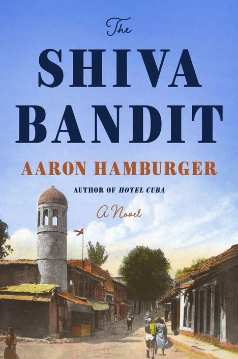 "The Shiva Bandit" von Aaron Hamburger. Eine Straßenszene mit alten Gebäuden und einem Turm in malerischer Umgebung.