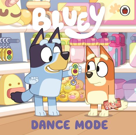Text: "BLUEY DANCE MODE". Illustration: Zwei cartoonartige Hunde im Spielzeugladen, lächelnd und fröhlich.