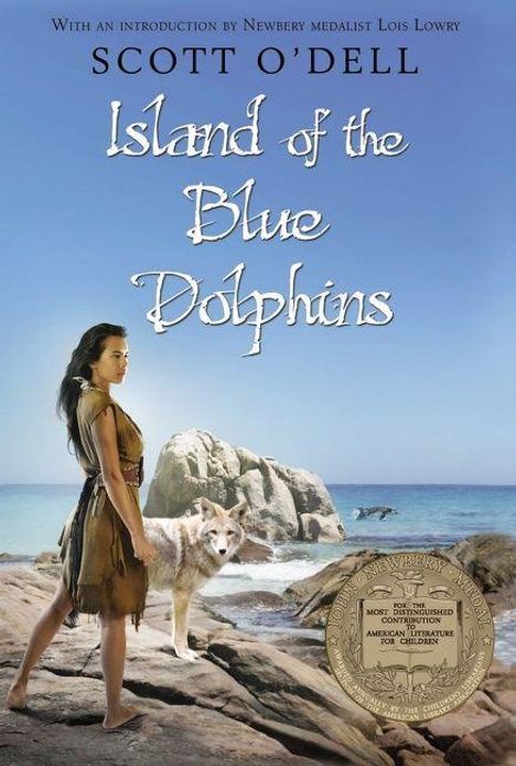 Text: "Scott O'Dell, Island of the Blue Dolphins". Eine Frau steht am Strand neben einem Wolf, im Hintergrund Felsen und Meer.