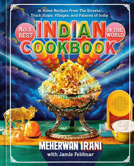„No. 1 Best Indian Cookbook“ in bunten Buchstaben. Reich verzierte Schale mit einem indischen Gericht, goldene Figur einer Kuh.
