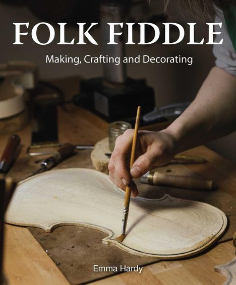 Text: "FOLK FIDDLE: Making, Crafting and Decorating" und "Emma Hardy". Eine Hand bemalt ein Violinende auf einem Tisch.