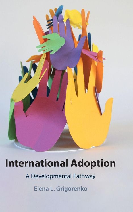 „International Adoption: A Developmental Pathway“ von Elena L. Grigorenko. Bunte ausgeschnittene Hände.