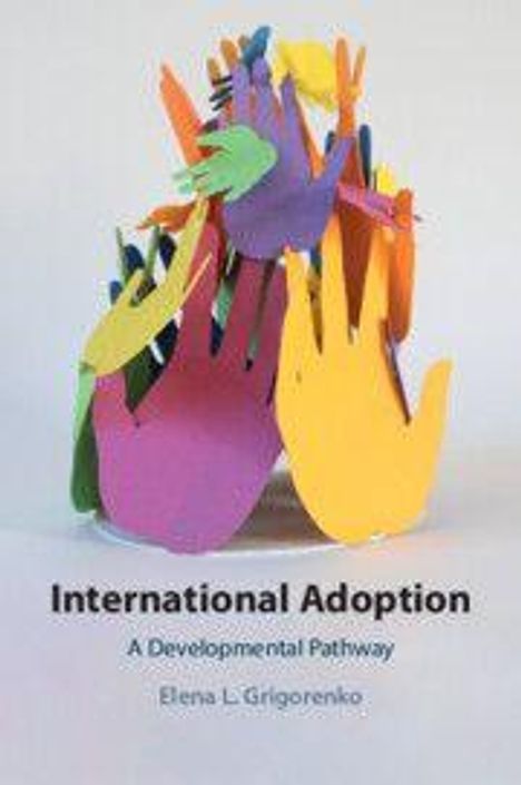 „International Adoption: A Developmental Pathway“ von Elena L. Grigorenko. Bunte Papierhände übereinander.