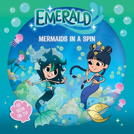 Text: "EMERALD", "MERMAIDS IN A SPIN", "AS SEEN ON TV!". Illustration: Zwei freundliche Meerjungfrauen mit bunten Flossen.