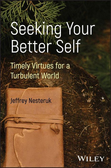 „Seeking Your Better Self: Timely Virtues for a Turbulent World“ von Jeffrey Nesteruk. Ein Lederbuch liegt auf Holz.