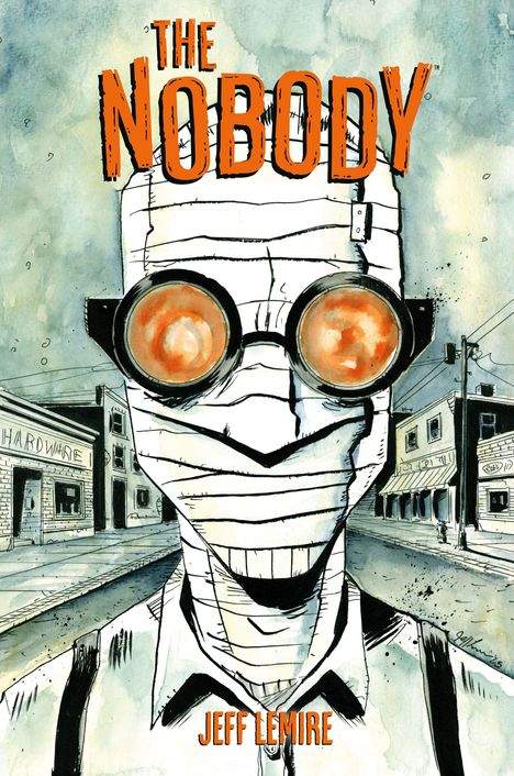 "THE NOBODY" oben, "JEFF LEMIRE" unten. Illustration: Bandagierter Mann mit Brille, Straße im Hintergrund.