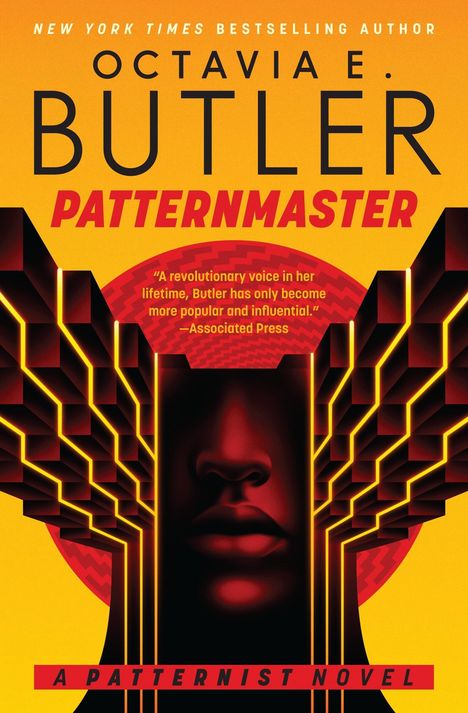 "OCTAVIA E. BUTLER" und "PATTERNMASTER" in großen Lettern. Gesicht, umgeben von geometrischen Formen, in orange und rot.