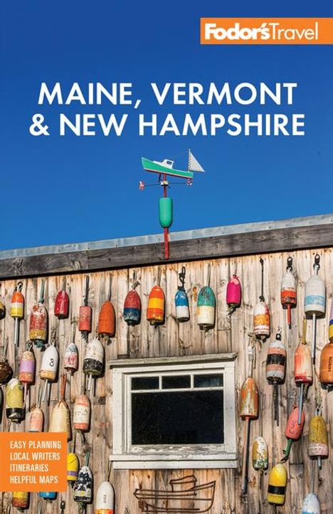 „Maine, Vermont & New Hampshire“, blauer Himmel, Holzwand mit bunten Bojen, Wetterfahne mit Flugzeugmotiv.