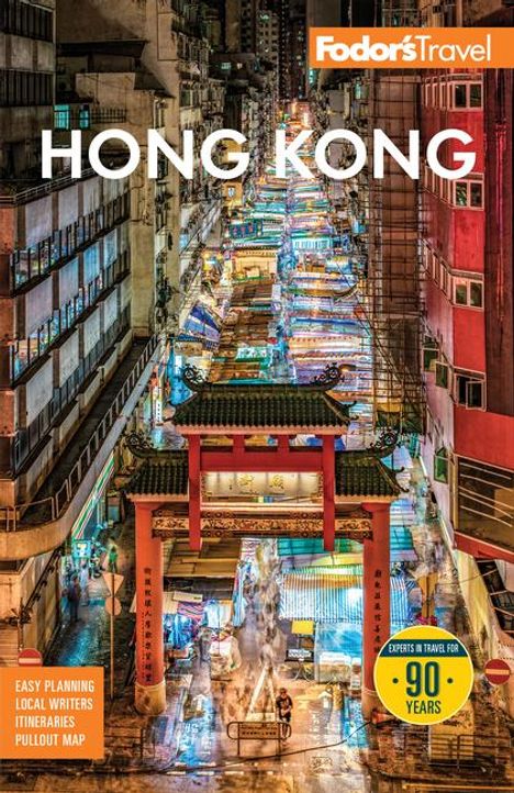 Text: "Fodor's Travel", "HONG KONG". Darstellung: Eine belebte, beleuchtete Straße mit Marktständen und traditionellem Torbogen.