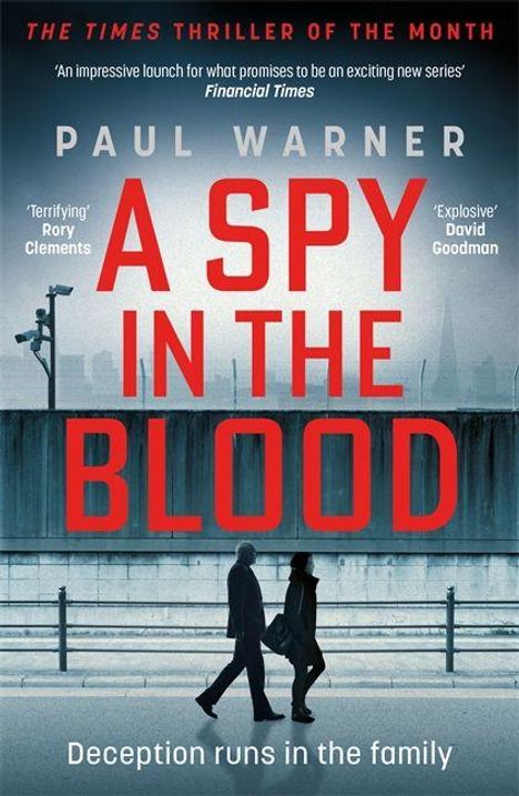 "A Spy in the Blood" von Paul Warner. "Terrifying", "Explosive". Zwei Menschen gehen an einer Mauer entlang.