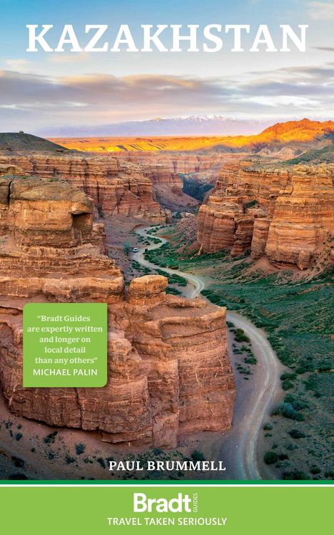 "KAZAKHSTAN" in weißen Buchstaben oben, Aussage von Michael Palin links. Canyonlandschaft mit grünem Talweg.