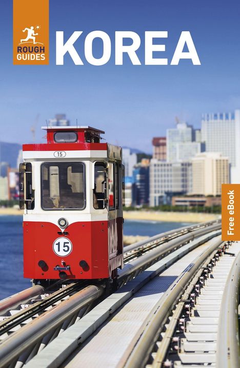 Text: "KOREA", "Free eBook", "ROUCH GUIDES". 
Eine rote Straßenbahn auf einer erhöhten Gleisstrecke mit Stadt im Hintergrund.