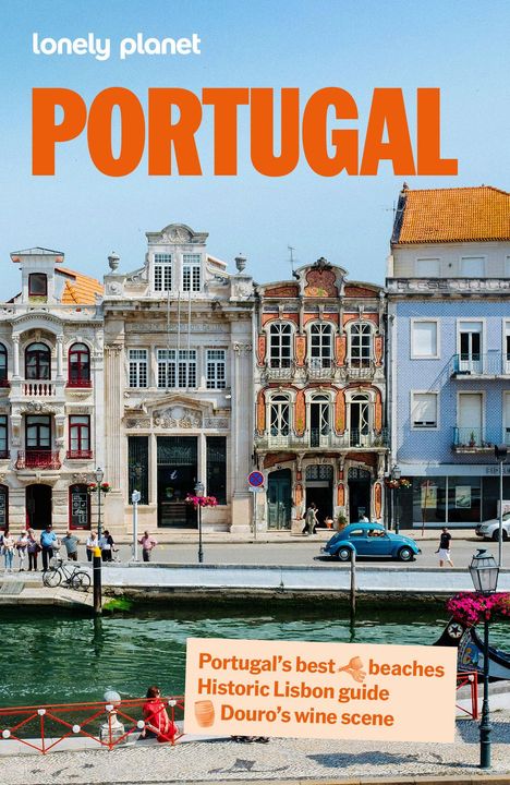 "Portugal’s best beaches, Historic Lisbon guide, Douro’s wine scene." Historische Gebäude an einem Fluss, blauer Himmel.