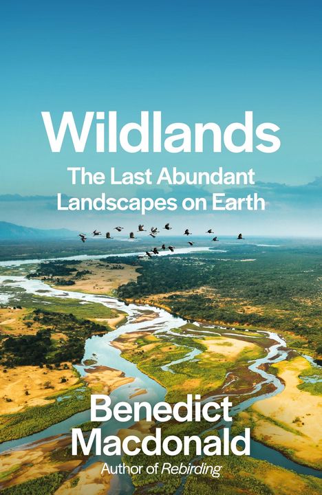 Text: "WILDLANDS", "BENEDICT MACDONALD", "COVER TO BE REVEALED". Zwei fliegende Vögel oben, Farbverlauf grün-blau.