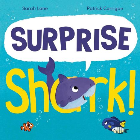 Text: "SURPRISE Shark!" Ein Hai mit großen Augen, umgeben von bunten Meeresfischen in leuchtend blauem Wasser.