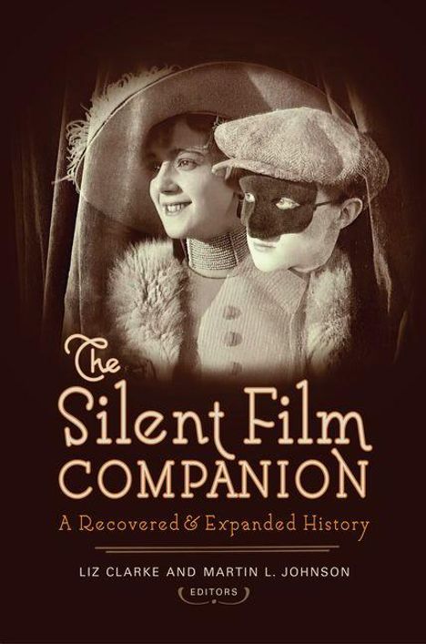 "The Silent Film Companion: A Recovered & Expanded History." Nostalgisches Foto: Frau mit Hut, Mann mit Maske.