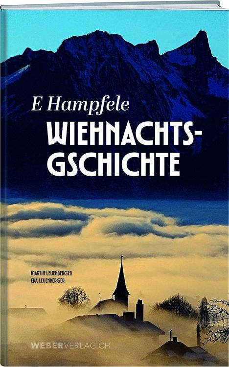 "E Hampfele Wiehnachtsgschichte" in weißer Schrift, zeigt eine winterliche Dorfkirche in Nebel mit Bergen im Hintergrund.