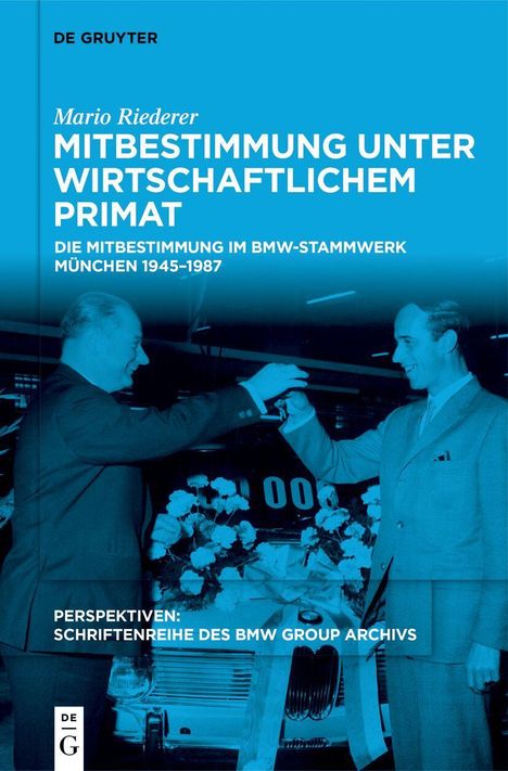 Titel: Mitbestimmung unter wirtschaftlichem Primat. Zwei Männer überreichen sich symbolisch einen Autoschlüssel.